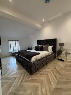 a bedroom with a large bed in a room at Modern Top Floor Aparment Near Beach Luxury in Crosby