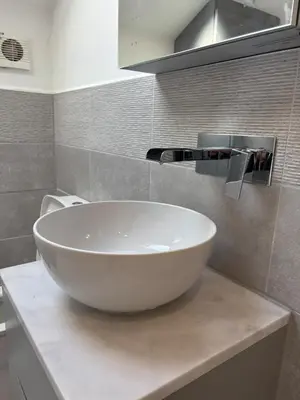 a white bowl sink on a counter in a bathroom at Modern Top Floor Aparment Near Beach Luxury in Crosby