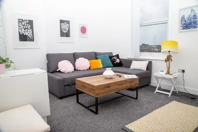 a living room with a couch and a coffee table at Santiago 4 in Southport