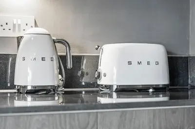 two toasters sitting on top of a kitchen counter at 2 Bed, 2 Bath New Build Apartment next to Albert Dock Liverpool & M&S Bank Arena - With Juliet Balcony - Monarchs Quay Arena Apartments - Close to Liverpool ONE Shopping, Exhibition Centre Liverpool, Pullman Hotel, Bars & Restaurants in Liverpool