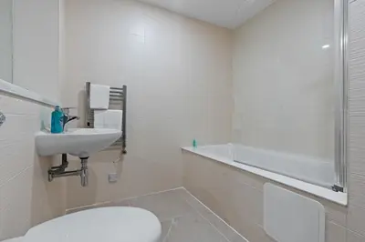 a bathroom with a sink and a toilet and a tub at 2 Bed, 2 Bath New Build Apartment next to Albert Dock Liverpool & M&S Bank Arena - With Juliet Balcony - Monarchs Quay Arena Apartments - Close to Liverpool ONE Shopping, Exhibition Centre Liverpool, Pullman Hotel, Bars & Restaurants in Liverpool