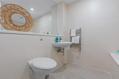 a white bathroom with a toilet and a sink at 2 Bed, 2 Bath New Build Apartment next to Albert Dock Liverpool & M&S Bank Arena - With Juliet Balcony - Monarchs Quay Arena Apartments - Close to Liverpool ONE Shopping, Exhibition Centre Liverpool, Pullman Hotel, Bars & Restaurants in Liverpool