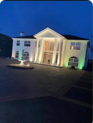 a white building with a fountain in front of it at night at Beautiful House in Blackpool near the beach in Marton
