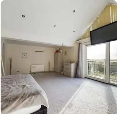 a bedroom with a bed and a large window at Beautiful House in Blackpool near the beach in Marton