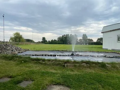 a water fountain in a field next to a building at Beautiful House in Blackpool near the beach in Marton