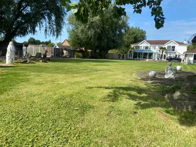 a yard with two stuffed animals sitting in the grass at Beautiful House in Blackpool near the beach in Marton