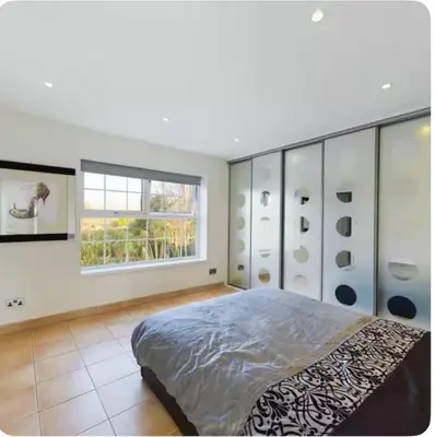a bedroom with a large bed and a window at Beautiful House in Blackpool near the beach in Marton