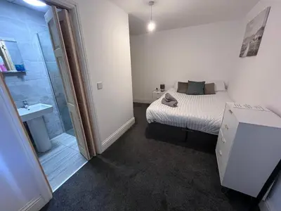a small bedroom with a bed and a shower at 6 bedroom house with Riverviews - Free parking in Preston