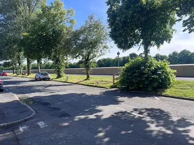 a car parked on the side of a street with trees at 6 bedroom house with Riverviews - Free parking in Preston
