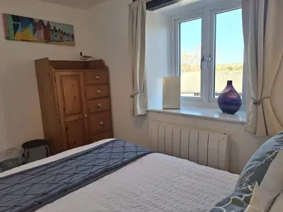 a bedroom with a bed and a window at The Coach House, Yealand Redmayne perfect for a family in a rural setting, bring your dogs and horse in Beetham