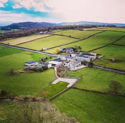 an aerial view of a large house in a field at The Dairy, Yealand Redmayne in a rural setting, bring your dogs and horse in Beetham