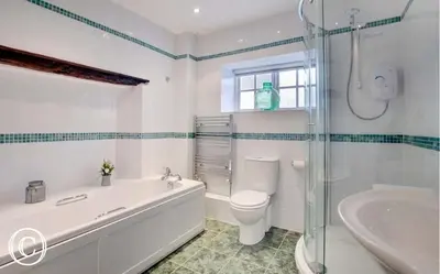 a bathroom with a tub and a toilet and a sink at The Old Farmhouse, Yealand Redmayne, a characterful cottage in a rural setting in Beetham