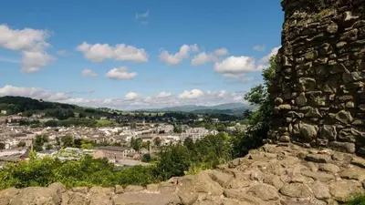 a view of a city from a rock wall at The Old Farmhouse, Yealand Redmayne, a characterful cottage in a rural setting in Beetham
