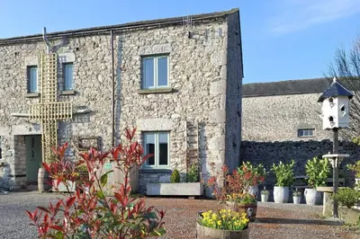 a stone building with plants in front of it at Corner Cottage, Yealand Redmayne, ideal family holiday, meet the resident animals in Beetham