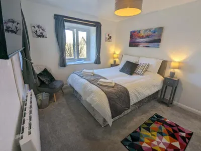 a bedroom with a bed and a chair and a window at Corner Cottage, Yealand Redmayne, ideal family holiday, meet the resident animals in Beetham