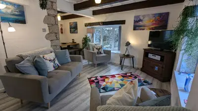 a living room with two couches and a tv at Corner Cottage, Yealand Redmayne, ideal family holiday, meet the resident animals in Beetham