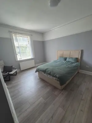 a bedroom with a bed and a wooden floor at Holly House in Liverpool