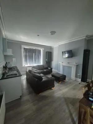 a living room with a couch and a table at Holly House in Liverpool