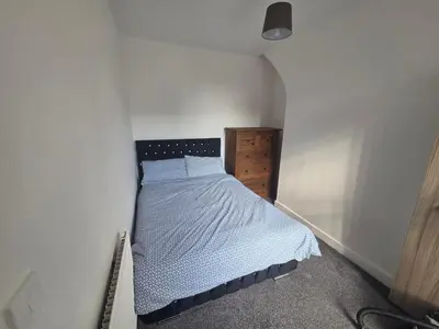a small bedroom with a bed in the corner at 61 coniston street next to anfield street in Liverpool