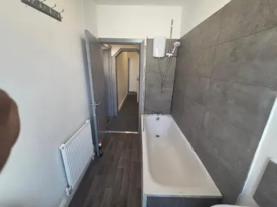 a bathroom with a bath tub in a room at 61 coniston street next to anfield street in Liverpool