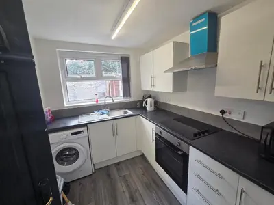 a kitchen with a sink and a washing machine at 61 coniston street next to anfield street in Liverpool