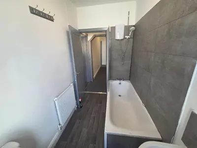 a bathroom with a bath tub and a toilet at 61 coniston street next to anfield street in Liverpool