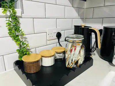 a black shelf with a jar of food on a kitchen counter at Stylish 2BR Stay- Preston City in Preston