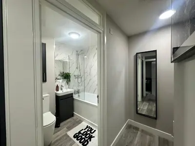 a bathroom with a shower and a toilet and a sink at Stylish 2BR Stay- Preston City in Preston