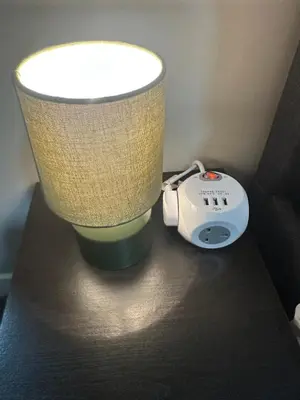 a lamp and a alarm clock on a table at Stylish 2BR Stay- Preston City in Preston