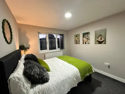 a bedroom with two dogs laying on a bed at Stylish 2BR Stay- Preston City in Preston