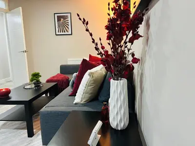 a living room with a vase with flowers on a table at Stylish 2BR Stay- Preston City in Preston