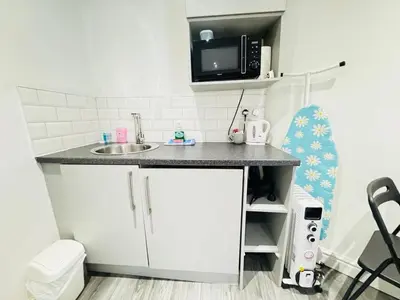 a small kitchen with a sink and a microwave at Bold Street Studio I in Liverpool