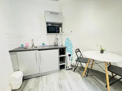 a small kitchen with a table and a sink at Bold Street Studio I in Liverpool