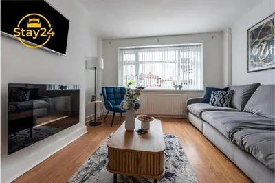 a living room with a couch and a table at Surrey Suite in Wallasey