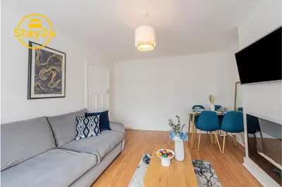 a living room with a couch and a table at Surrey Suite in Wallasey