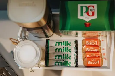 a shelf with some food and a bottle of milk at Luxury Liverpool City Centre Apartment with Balcony, Sleeps 8, Near Liverpool ONE and Royal Albert Docks in Liverpool