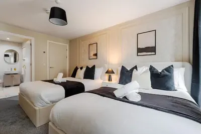 a hotel room with two beds and a room at Luxury Liverpool City Centre Apartment with Balcony, Sleeps 8, Near Liverpool ONE and Royal Albert Docks in Liverpool