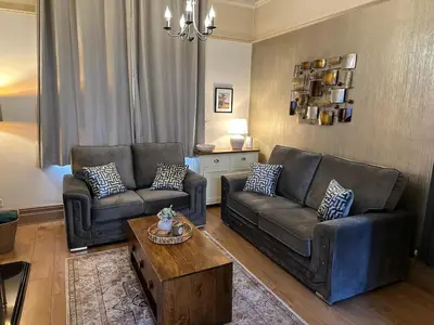 a living room with two couches and a coffee table at Comfy Stay Near City & Station in Preston