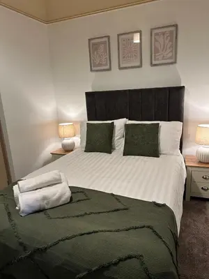 a bedroom with a large white bed with two lamps at Comfy Stay Near City & Station in Preston