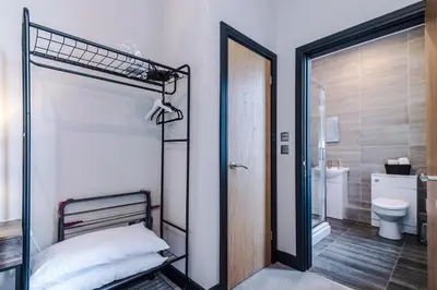 a bedroom with a bunk bed and a bathroom at Bright Flat with Wifi, Close to Beach! in Wallasey