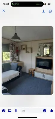 a living room with a couch and a flat screen tv at the mountain view in Millom