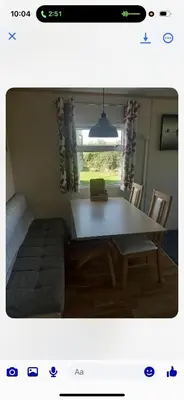 a living room with a table and a couch at the mountain view in Millom