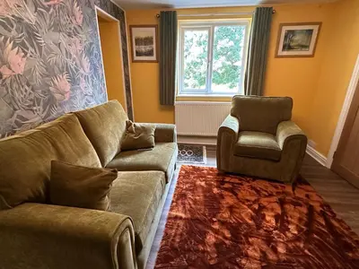 a living room with a couch and a chair at The Rookery Sandside - Luxury Coastal Home South Lake District and Beaches