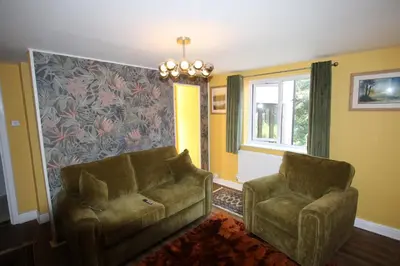 a living room with a couch and two chairs at The Rookery Sandside - Luxury Coastal Home South Lake District and Beaches