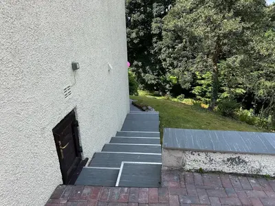 a stairway leading up to a building with a door at The Rookery Sandside - Luxury Coastal Home South Lake District and Beaches