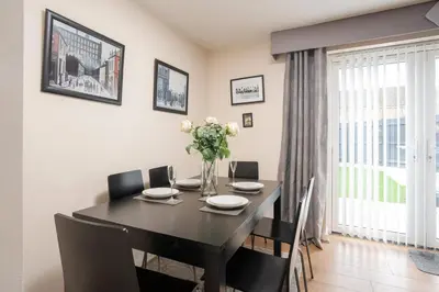 a dining room with a table and chairs and a window at 2 Bedroom Home with Garden and Free Parking in Litherland