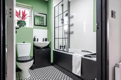 a bathroom with a toilet and a sink at 2 Bedroom Home with Garden and Free Parking in Litherland