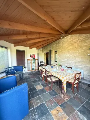a room with a table and chairs and a wooden ceiling at Grange Cottage in Belmont