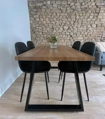 a wooden table with black chairs around it at High Street Apartment in Garstang