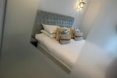 a white bed with two pillows on it at Luxury stay in Central Southport in Southport